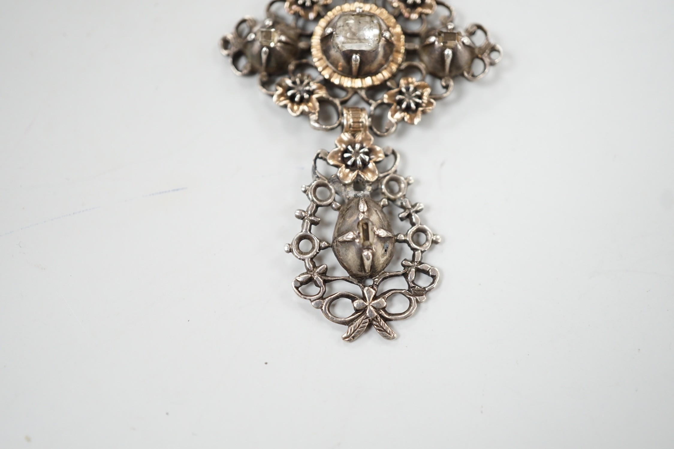 A continental antique pierced white and yellow metal, diamond set three tier drop brooch, 70mm, gross weight 13.2 grams.